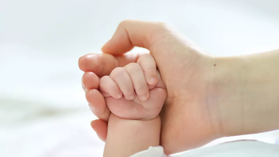 Holding infant hand